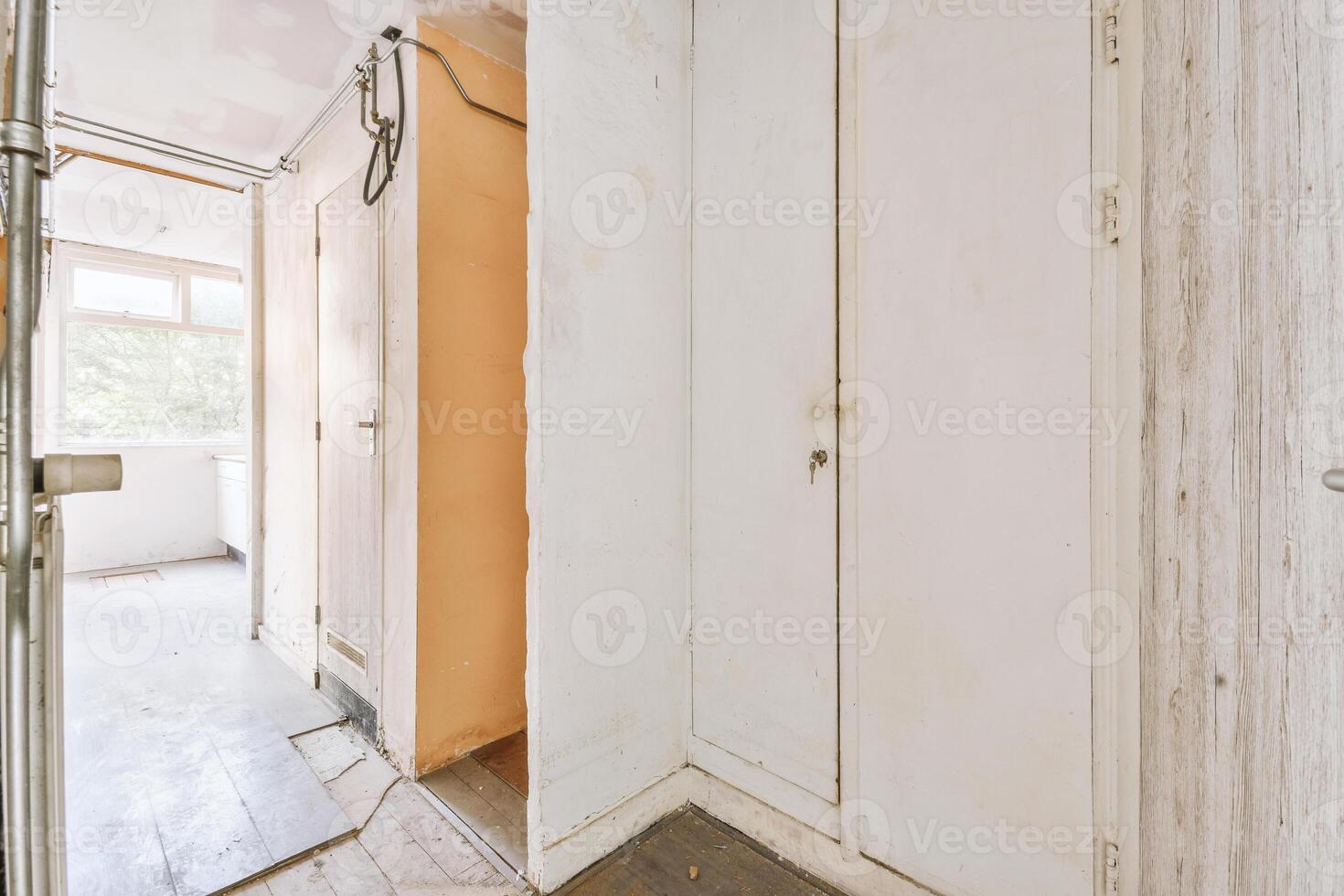 A hallway with a door and a door knob photo