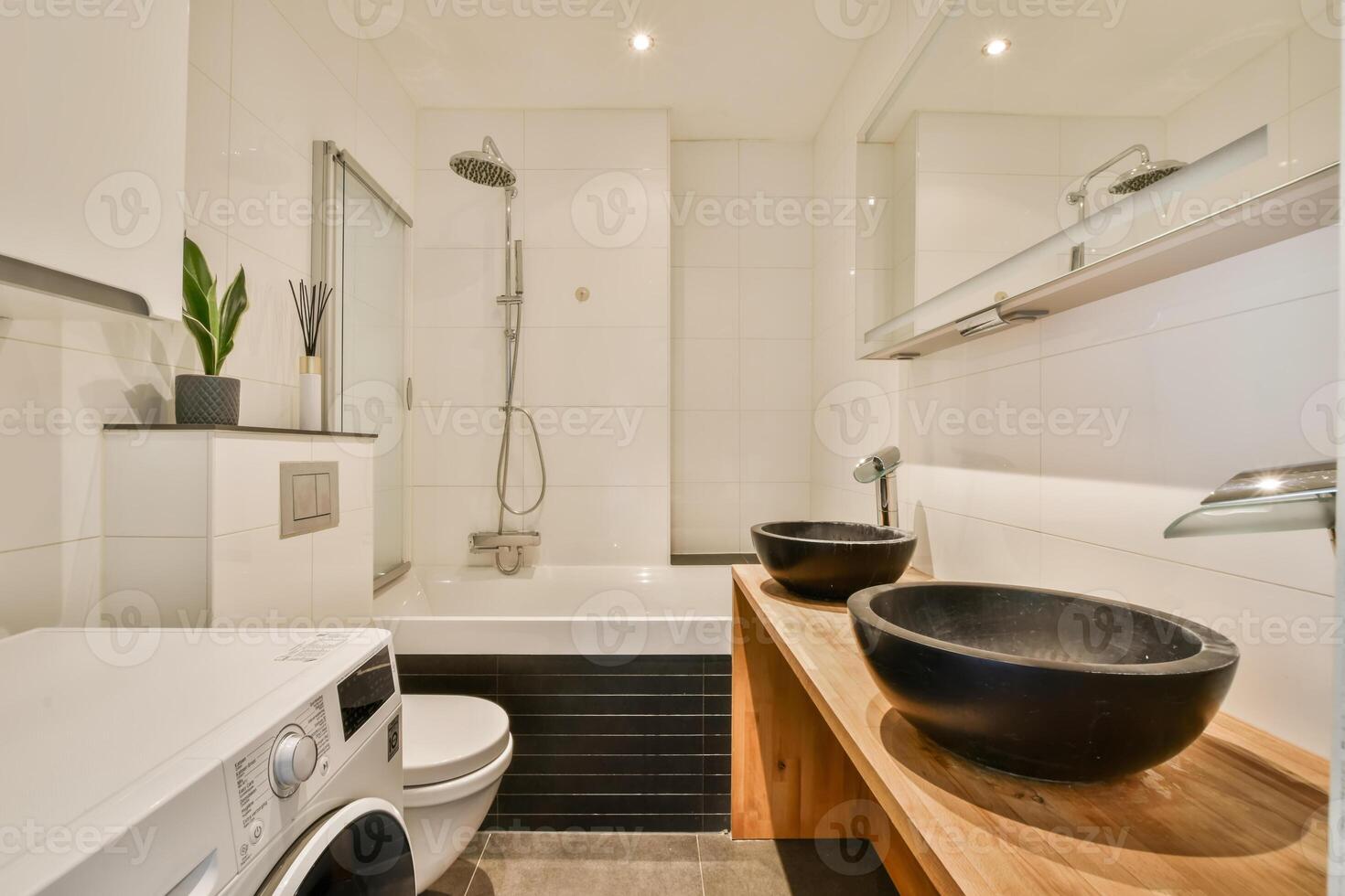 A bathroom with a sink, toilet, and a washer photo