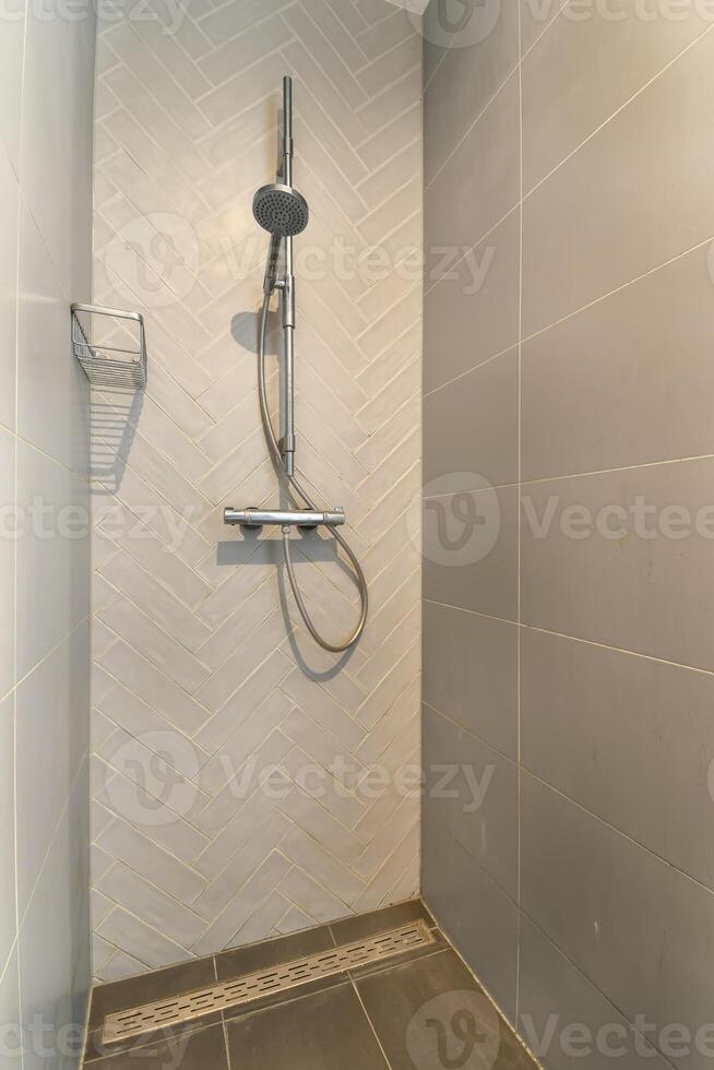 A shower with a shower head and a shower head photo