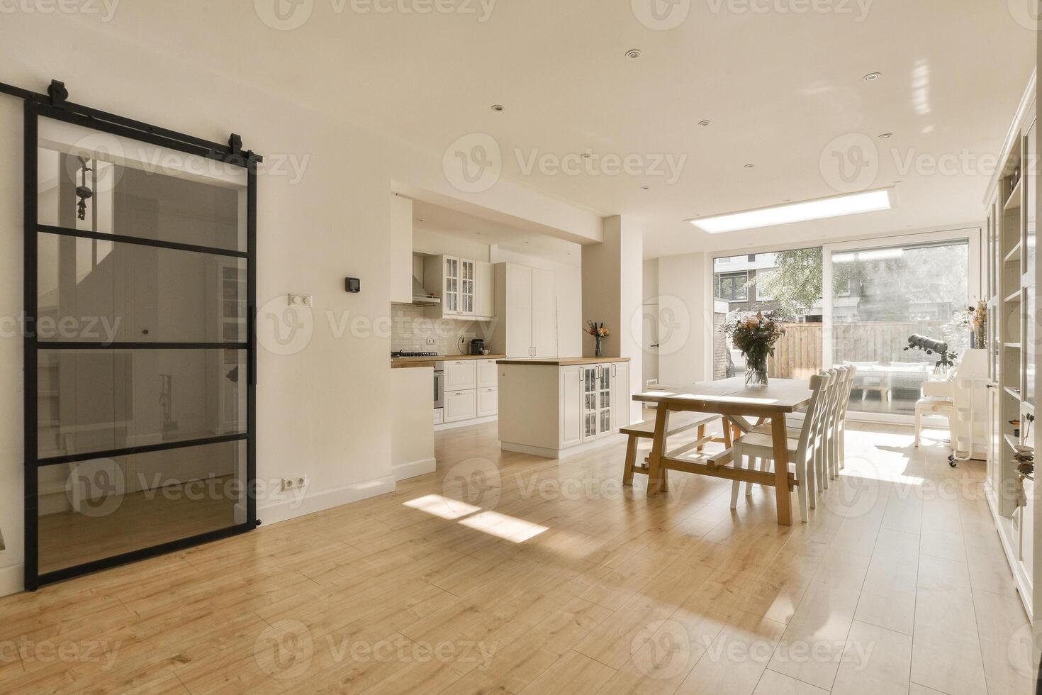 A kitchen with a sliding door and a dining table photo