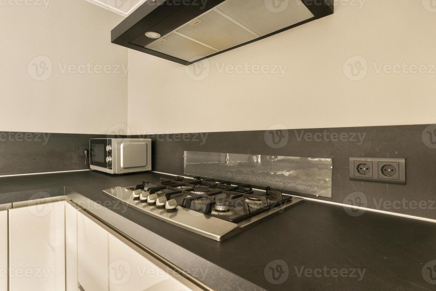 A kitchen with a stove and microwave photo