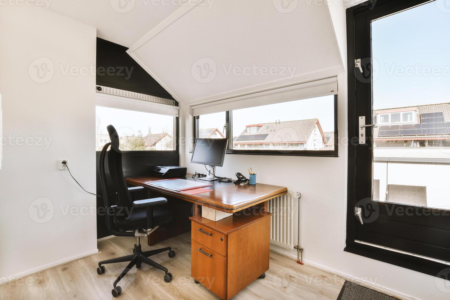 A home office with a desk and chair photo