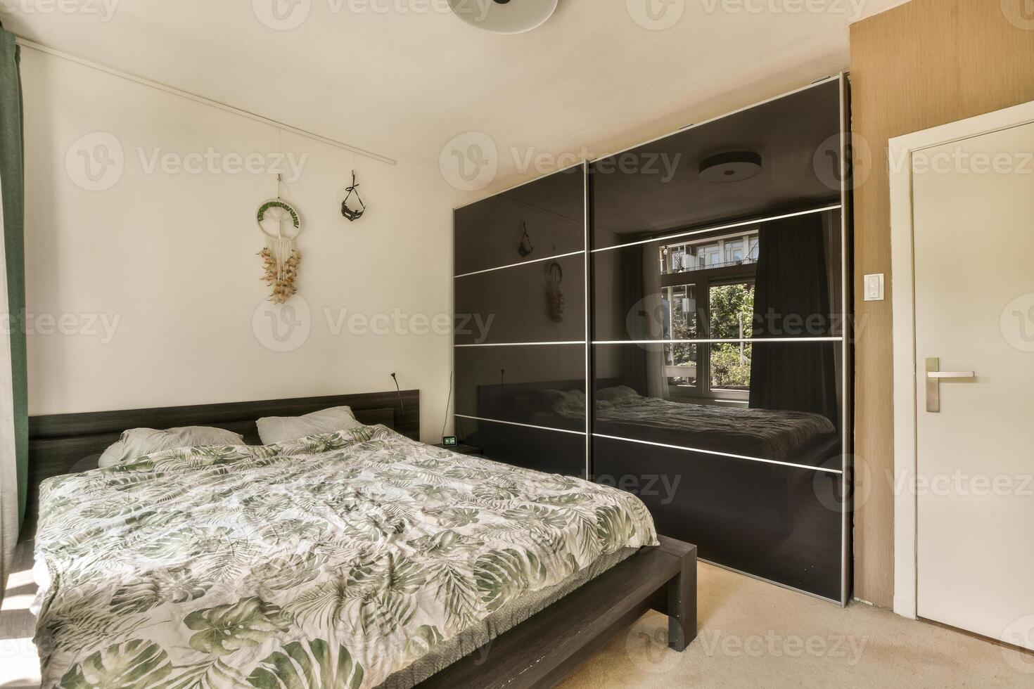 A bedroom with a bed and a wardrobe photo