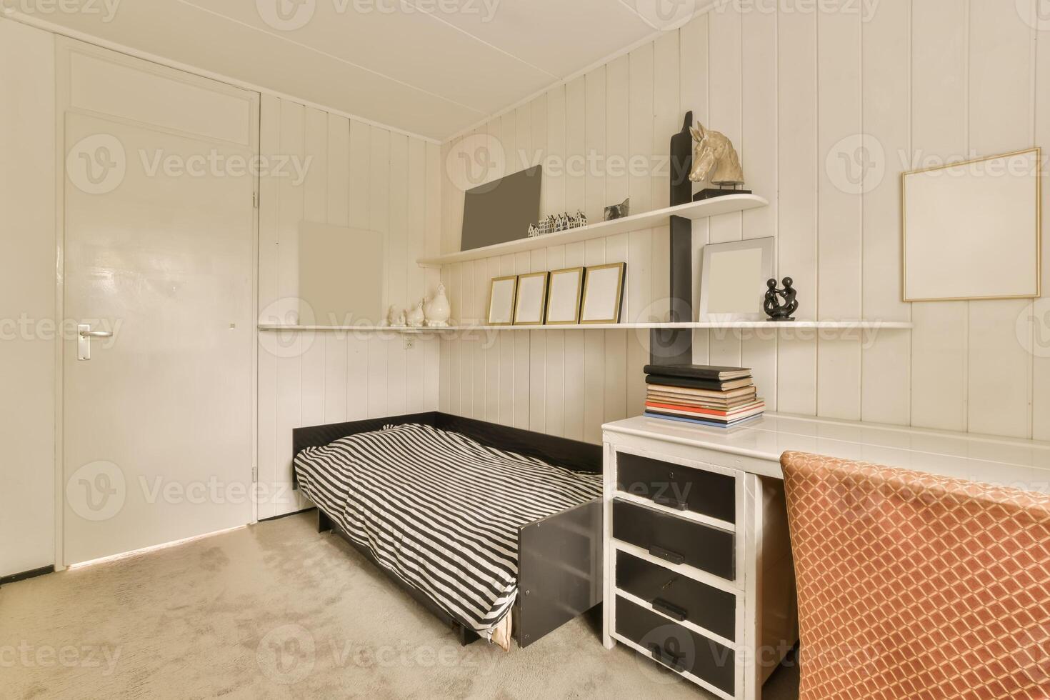 A small room with a bed and a desk photo
