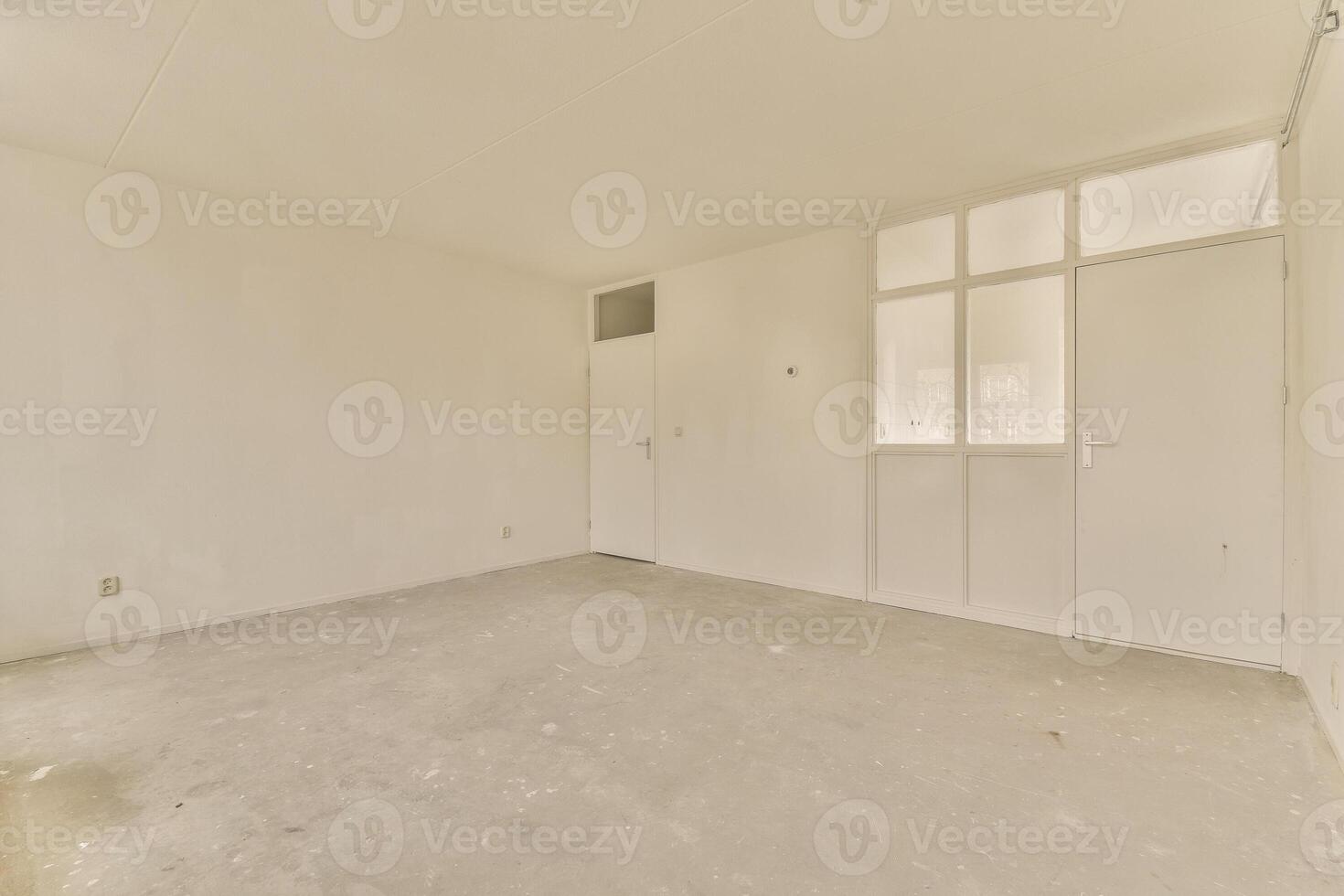 An empty room with a door and a window photo