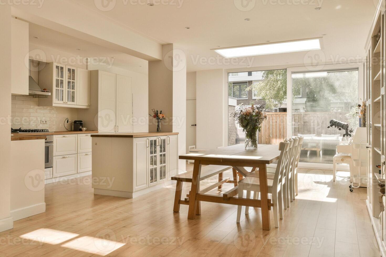 A kitchen with a table and chairs in it photo