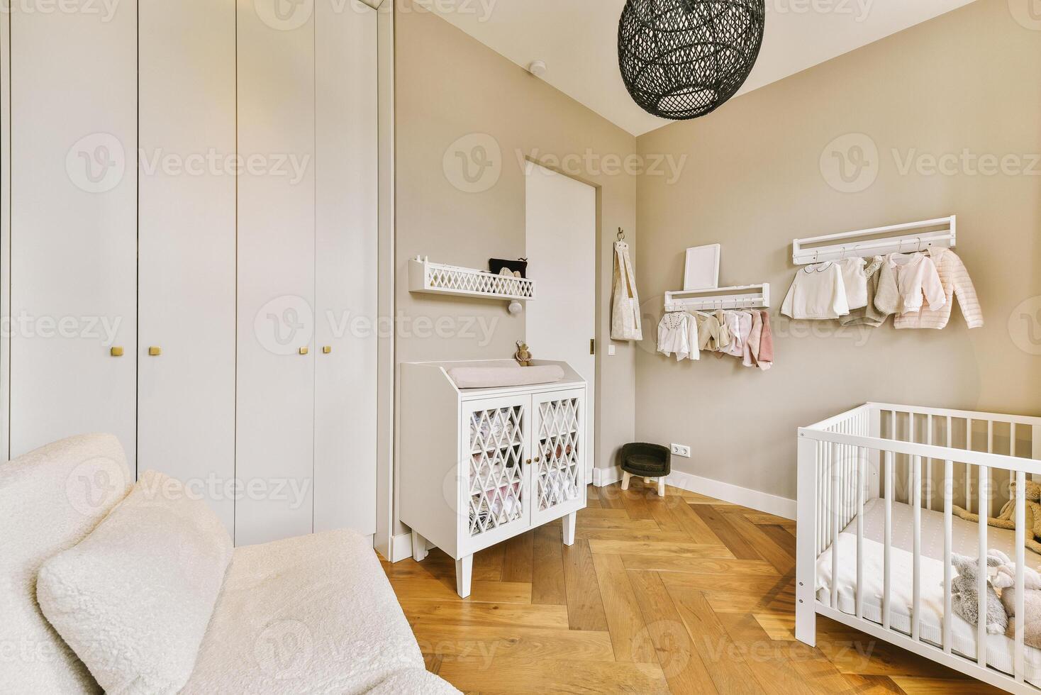 A baby's room with a crib, dresser and a white crib photo