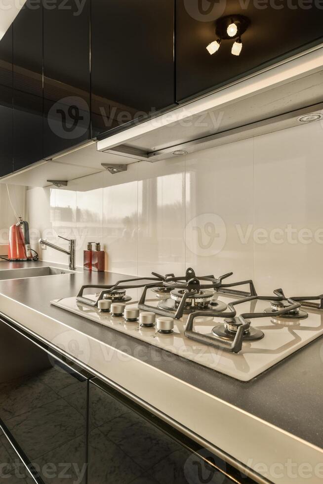 A kitchen with a stove and sink photo