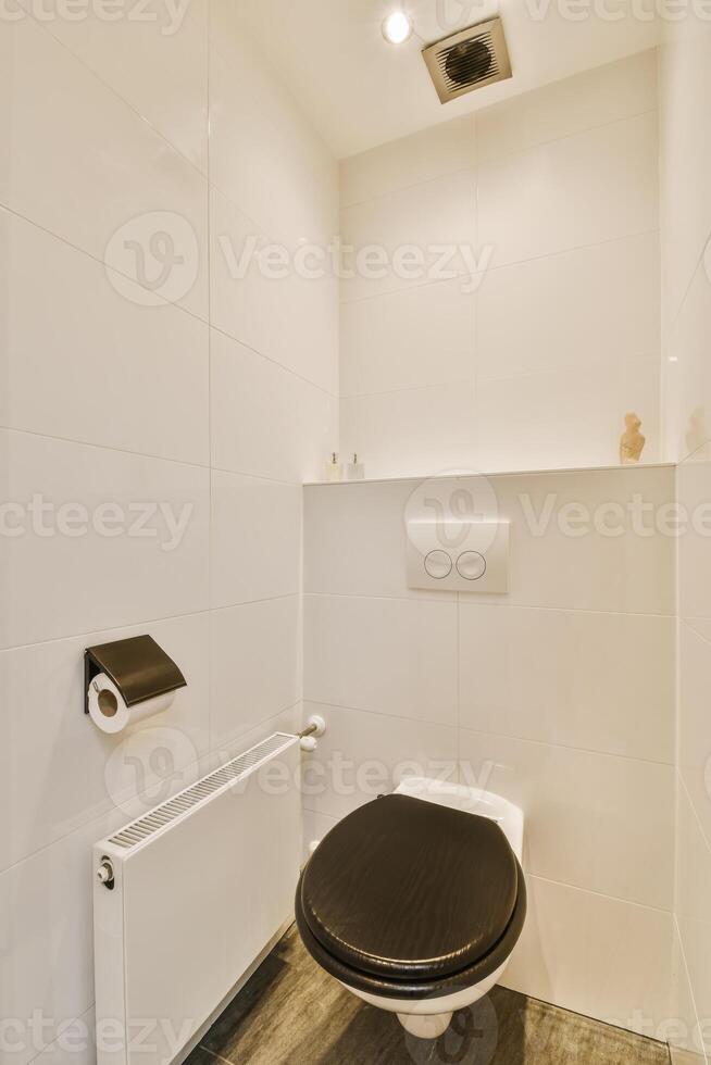 A bathroom with a toilet and a shower photo