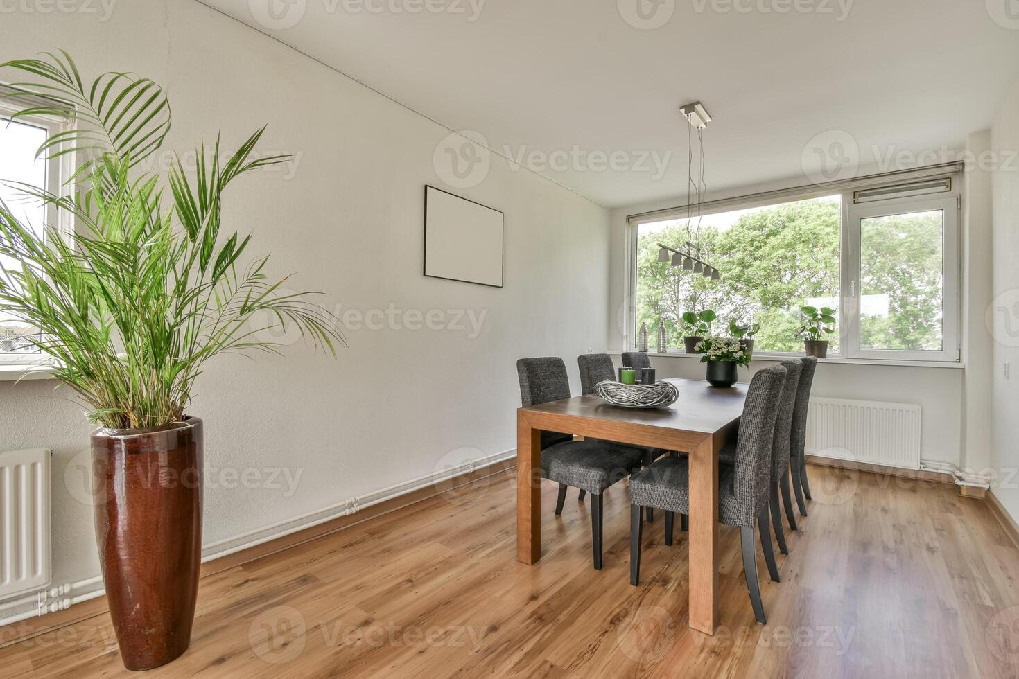 A dining room with a table and chairs photo