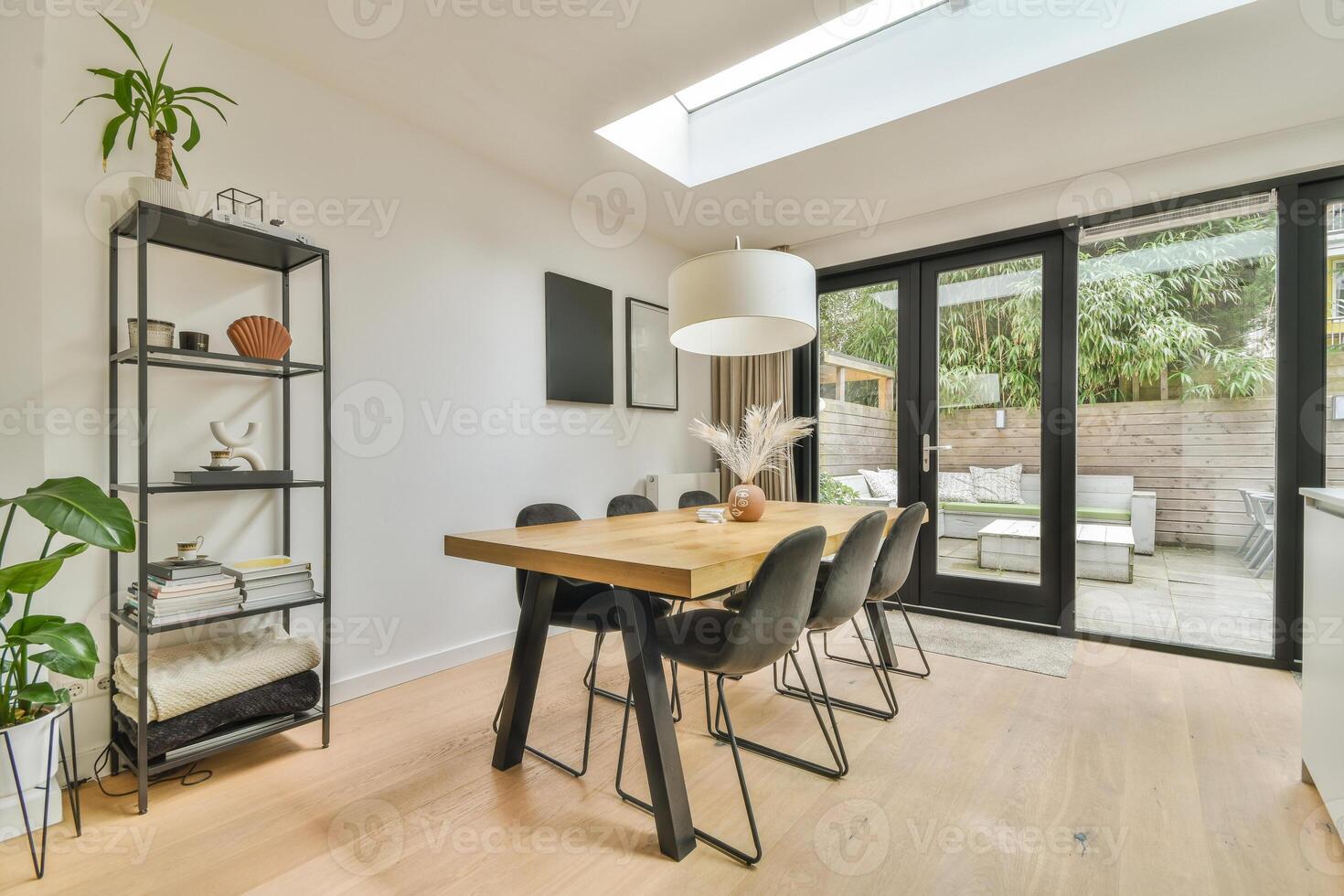 A dining room with a skylight and a table photo