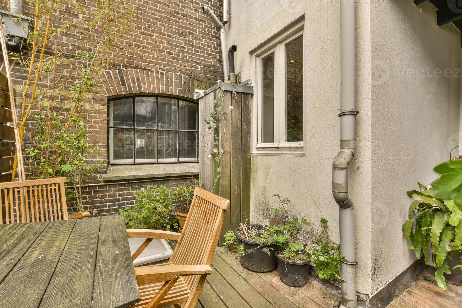A wooden table and chairs on a patio photo