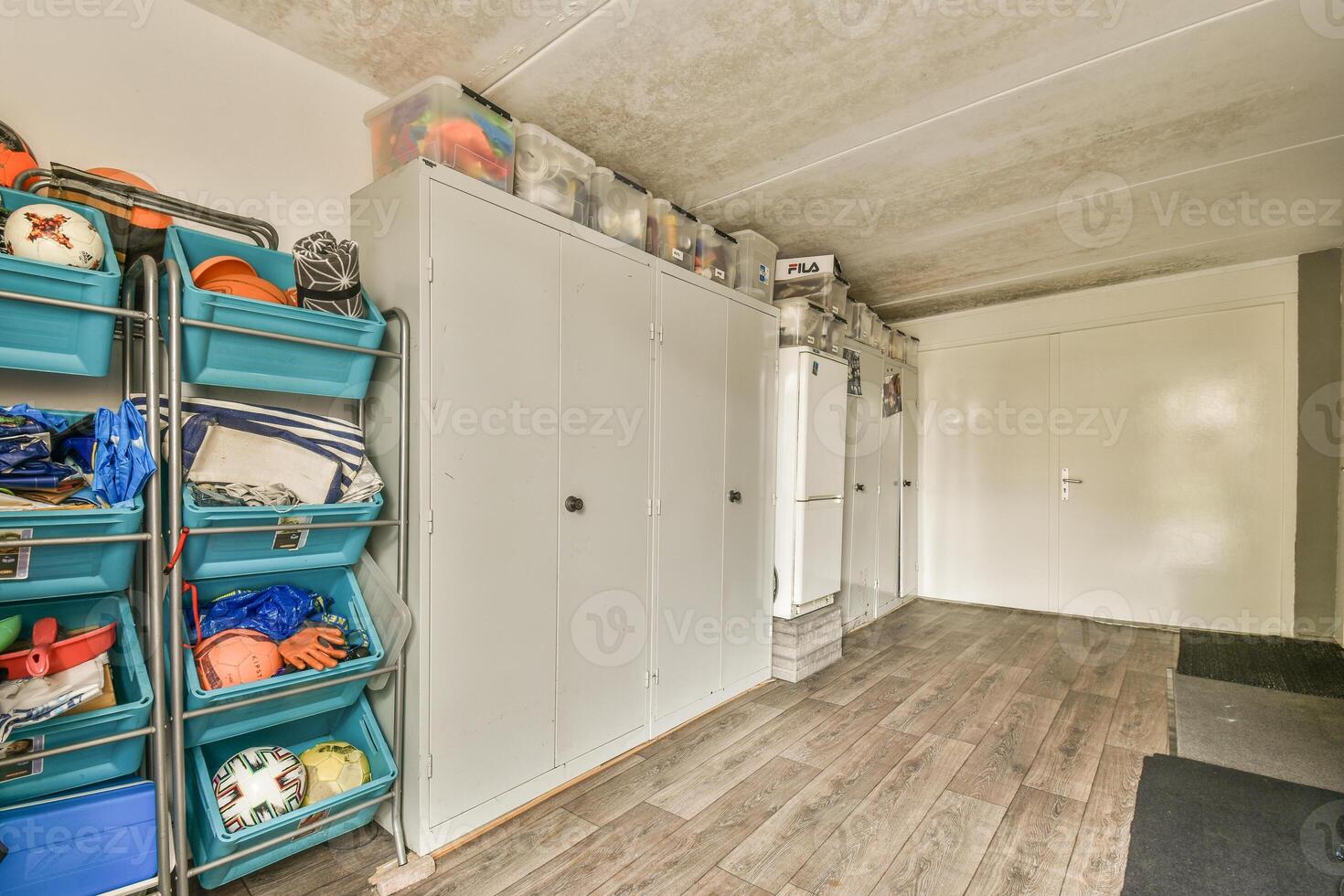 A garage with a lot of storage space and a lot of toys photo