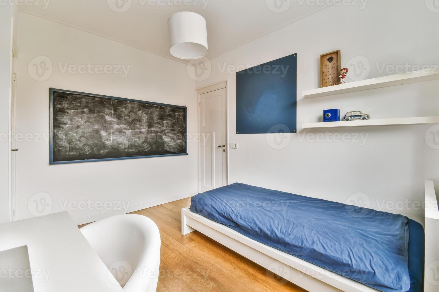 A bedroom with a blue bed and a chalkboard photo