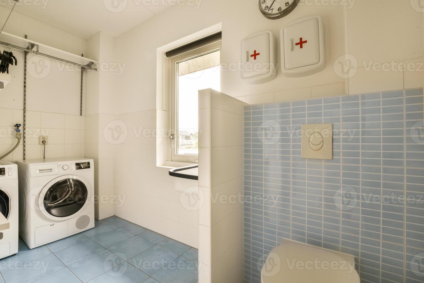 A small laundry room with a washer and dryer photo