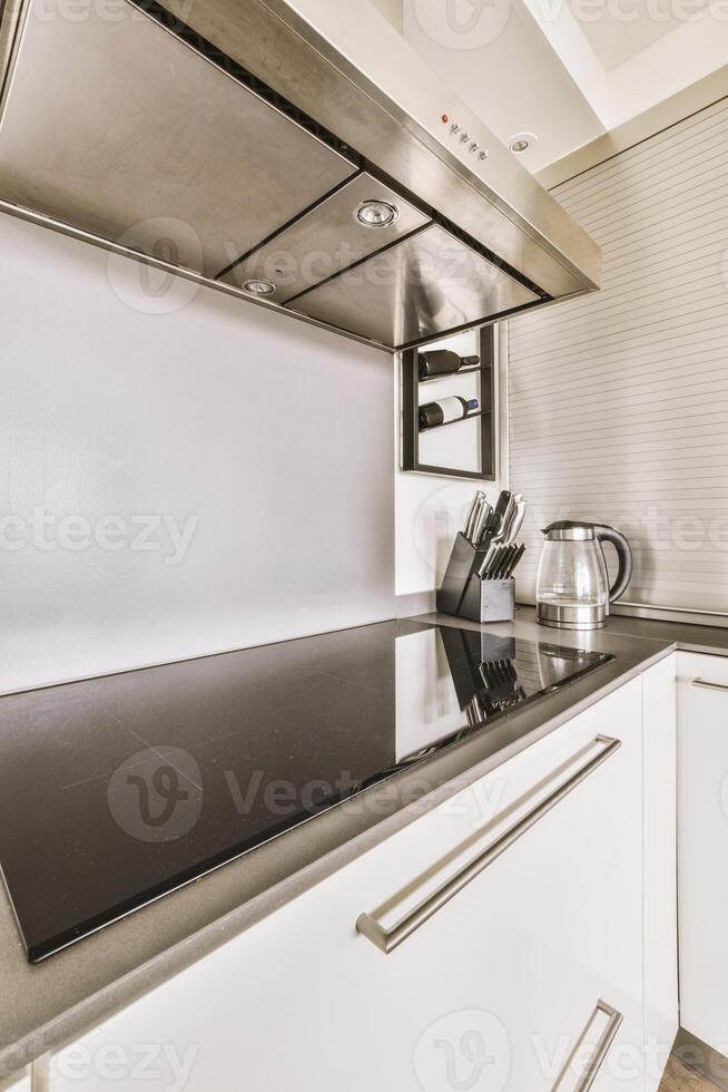 A kitchen with a stove and a sink photo