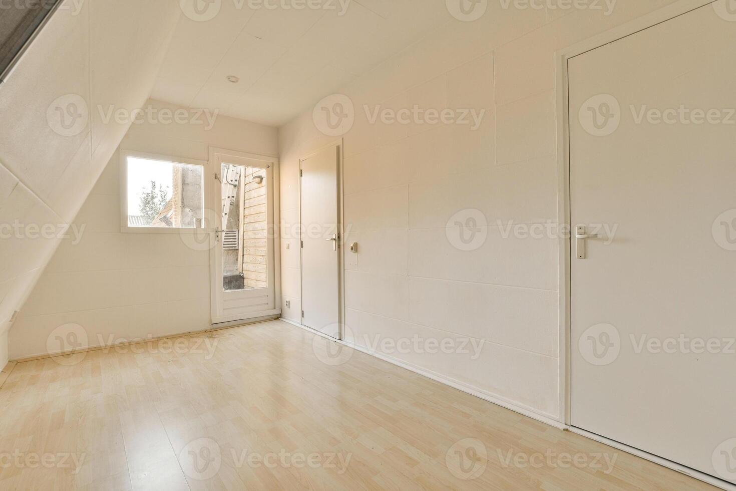 An empty room with wooden floors and white doors photo