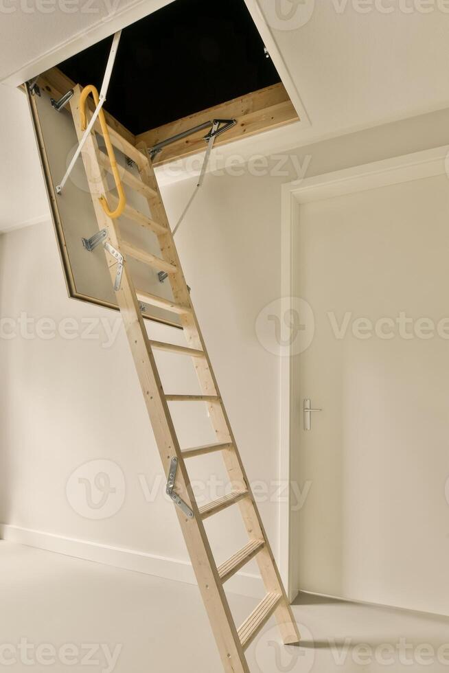 A ladder in a room with a door open photo