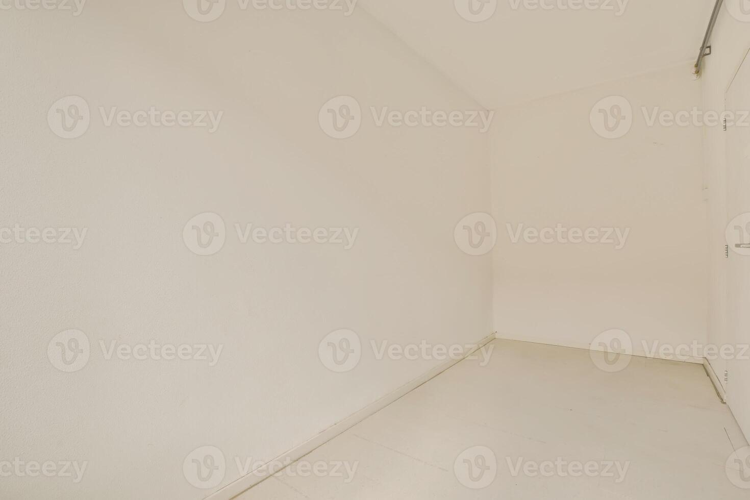 An empty room with white walls and a door photo
