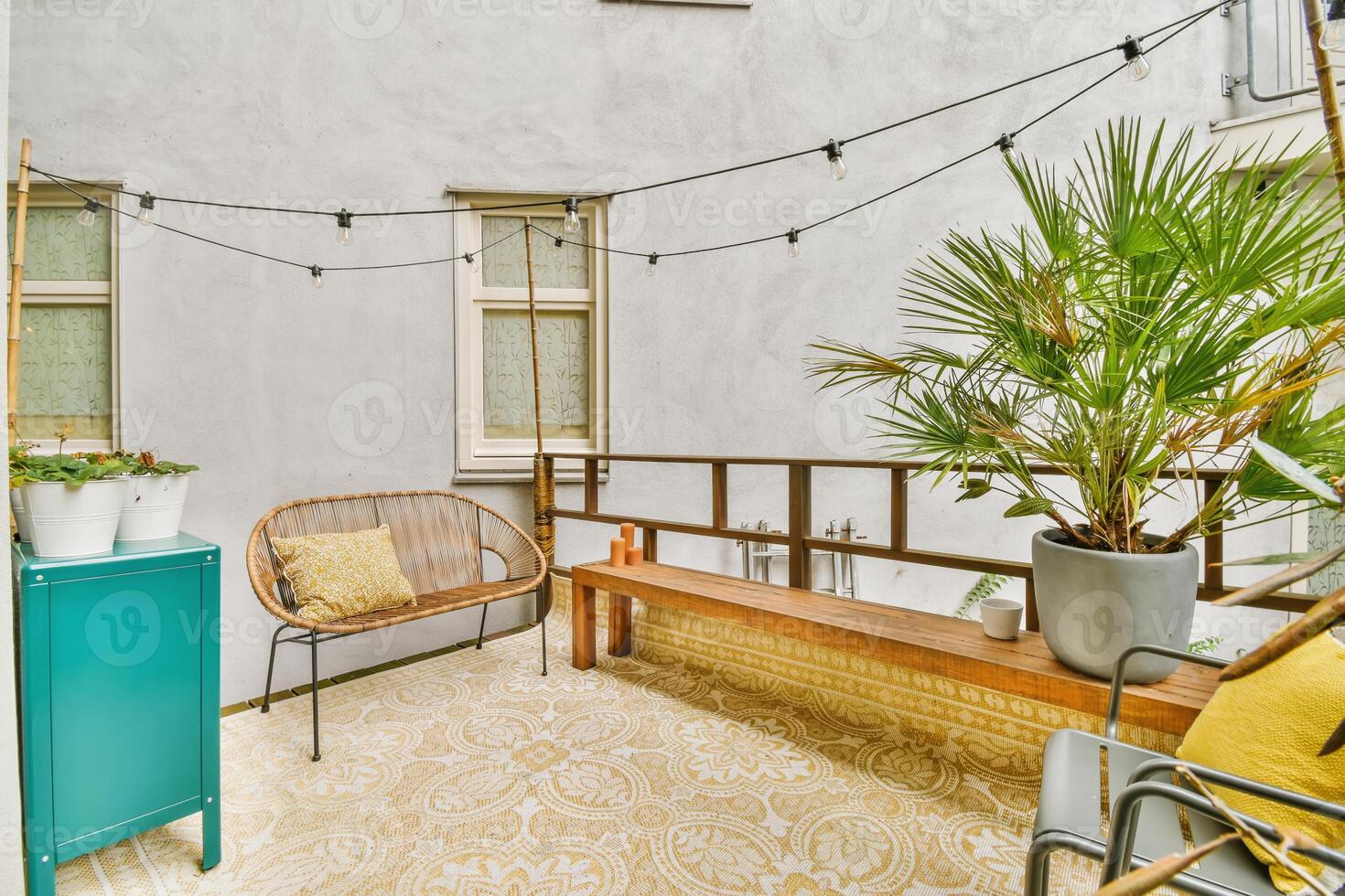 A balcony with a bench, plants and a table photo