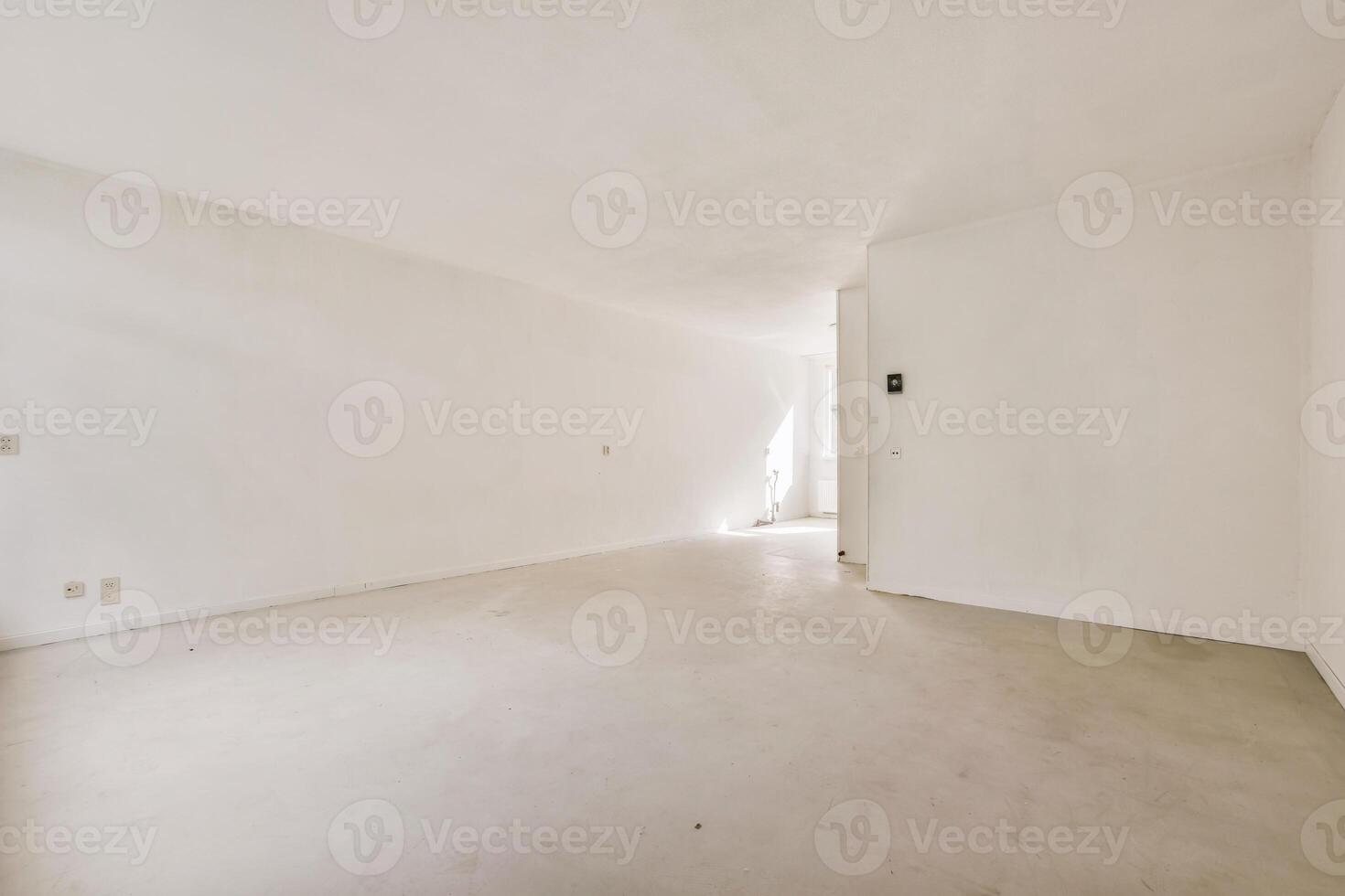 An empty room with white walls and a door photo