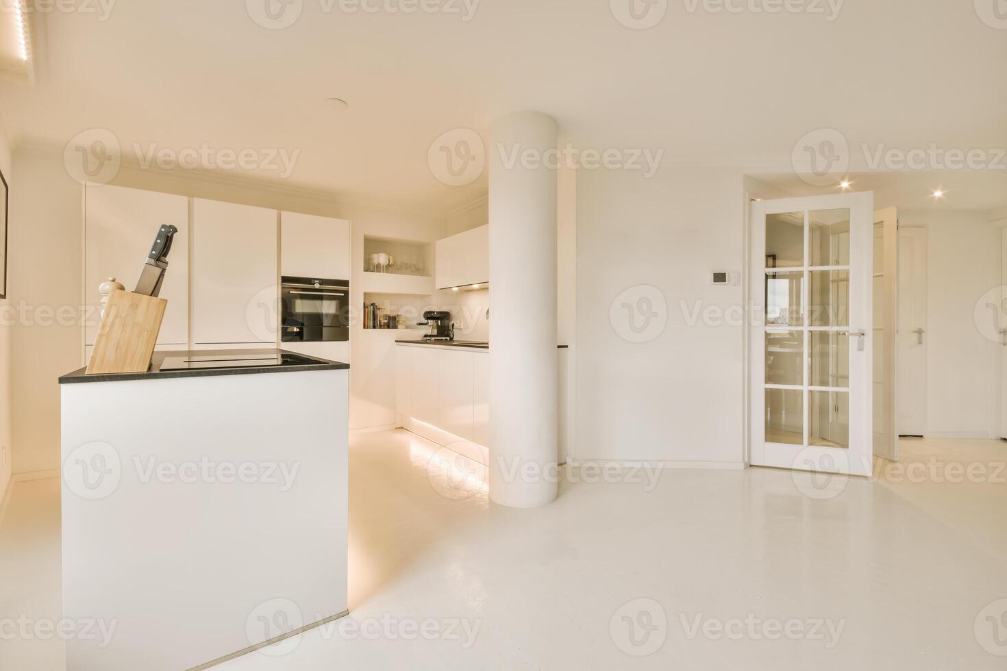 A white kitchen with a white counter top photo