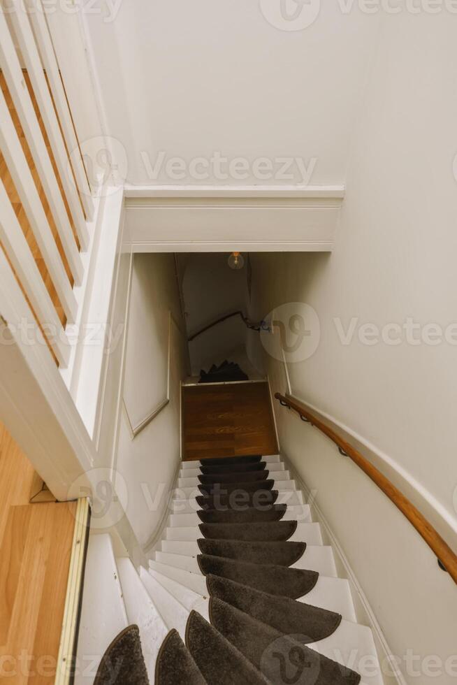 A staircase with a black carpet photo