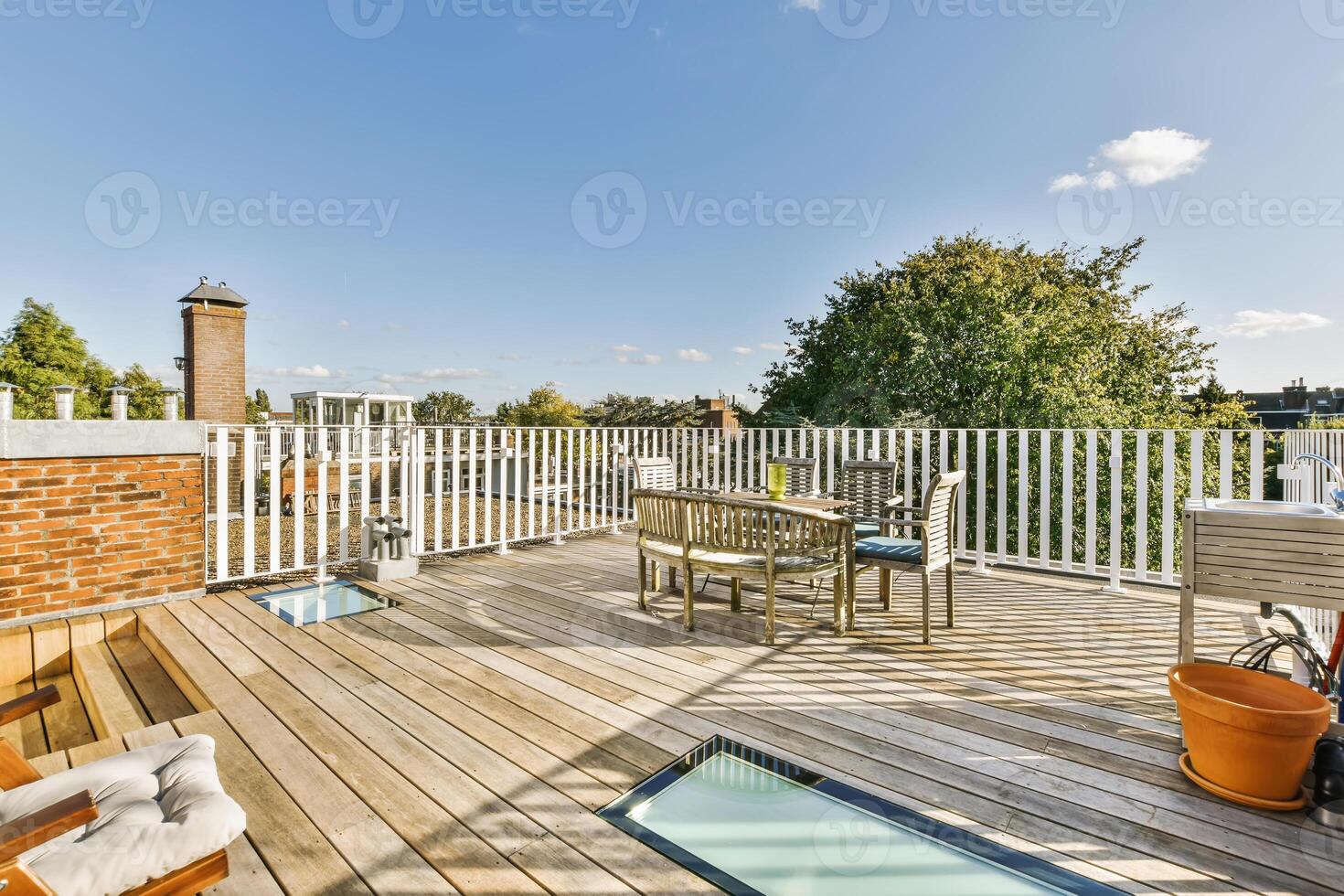 A wooden deck with a table and chairs photo