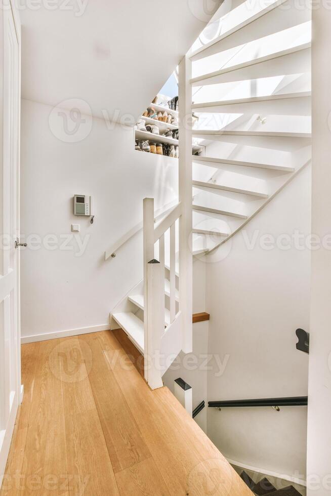 A white staircase in a house with a wooden floor photo