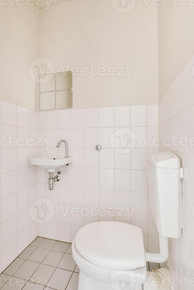 A white toilet in a bathroom photo