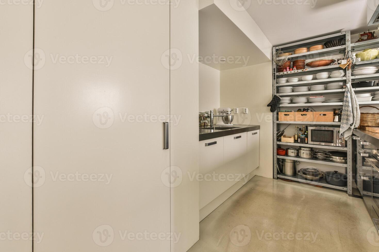 A kitchen with a lot of white cabinets and a lot of shelves photo