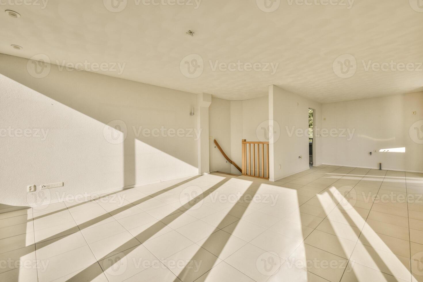 An empty room with sunlight shining through the windows photo