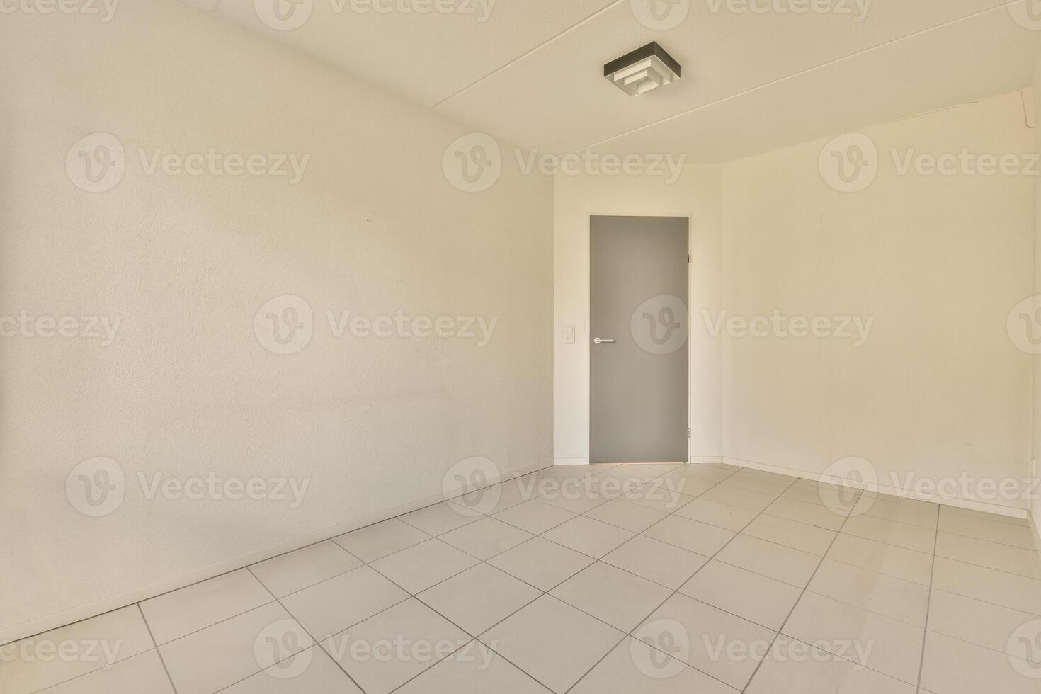 Empty room with tile floor and white walls photo