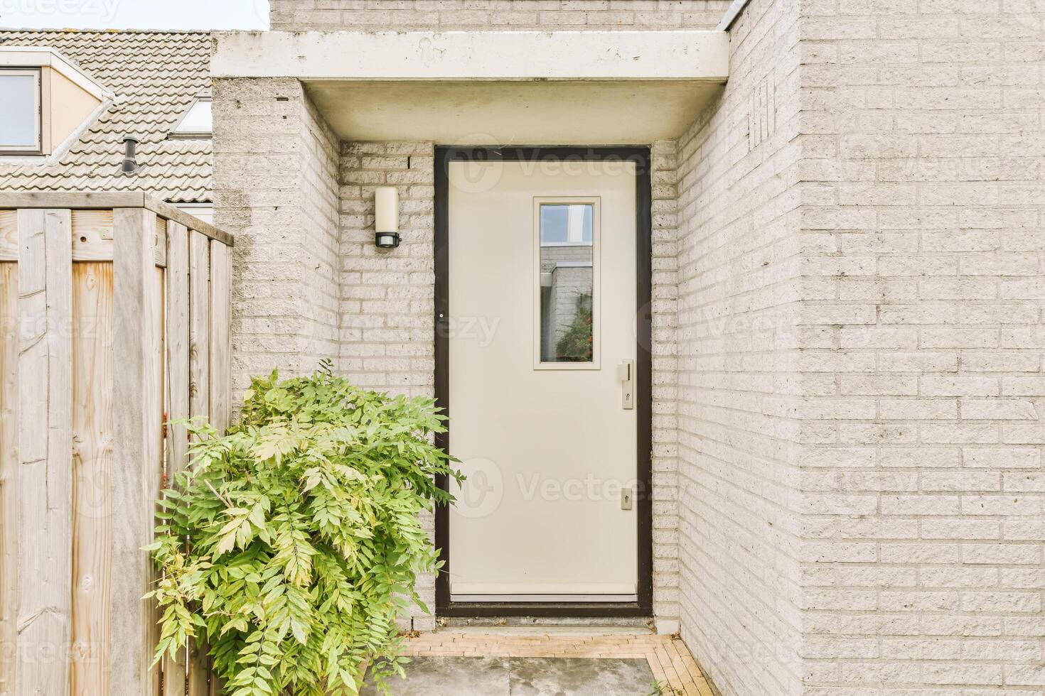 A door is open in front of a brick wall photo