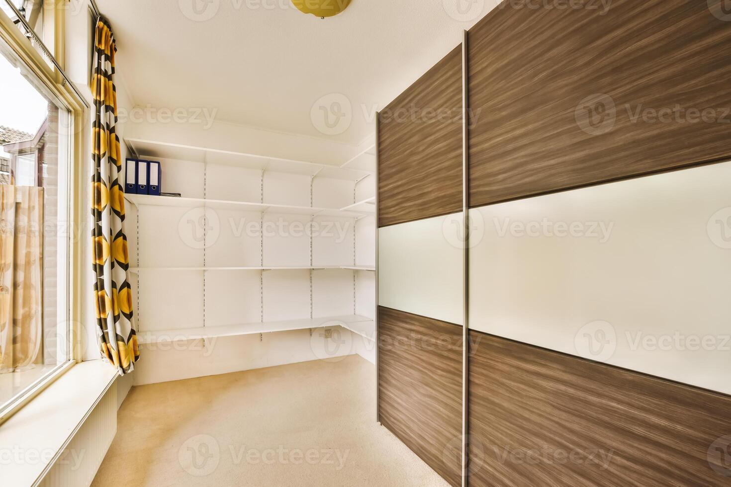 A room with a large closet and a window photo