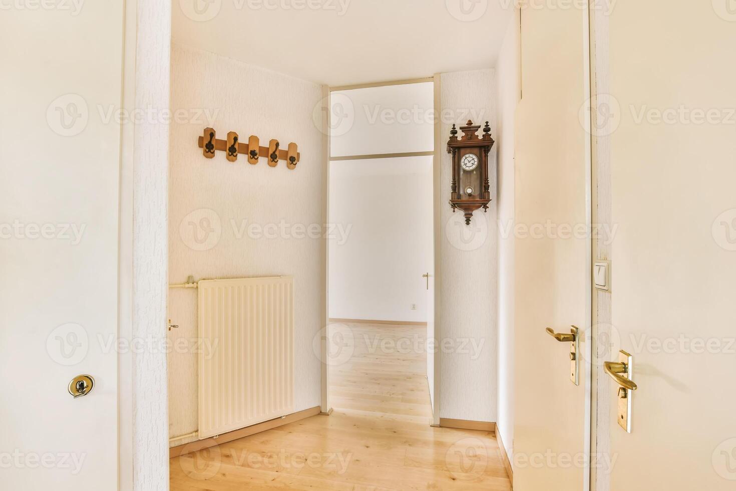 A hallway with a wooden floor and a clock photo