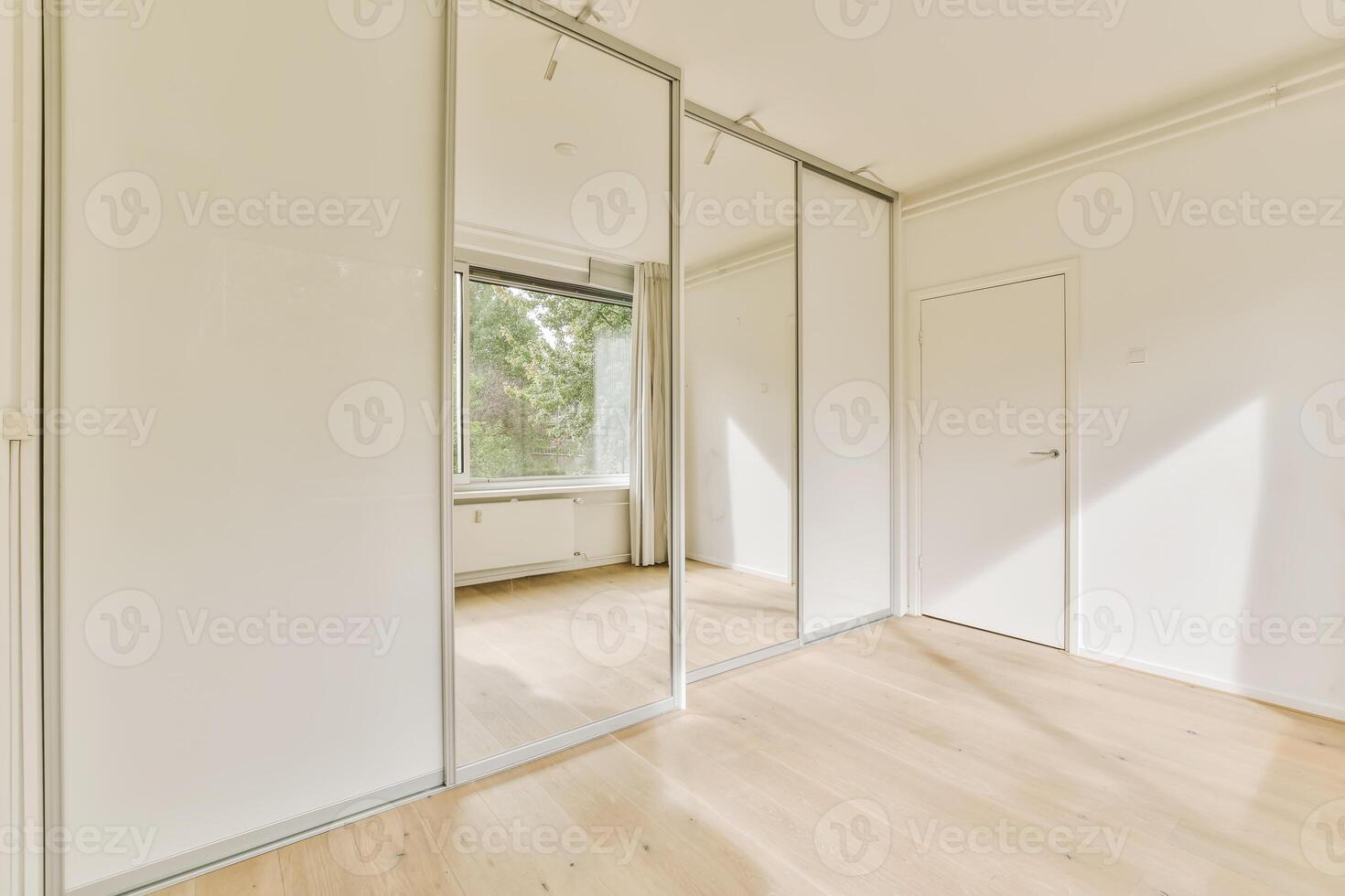 A room with white walls and wooden floors photo