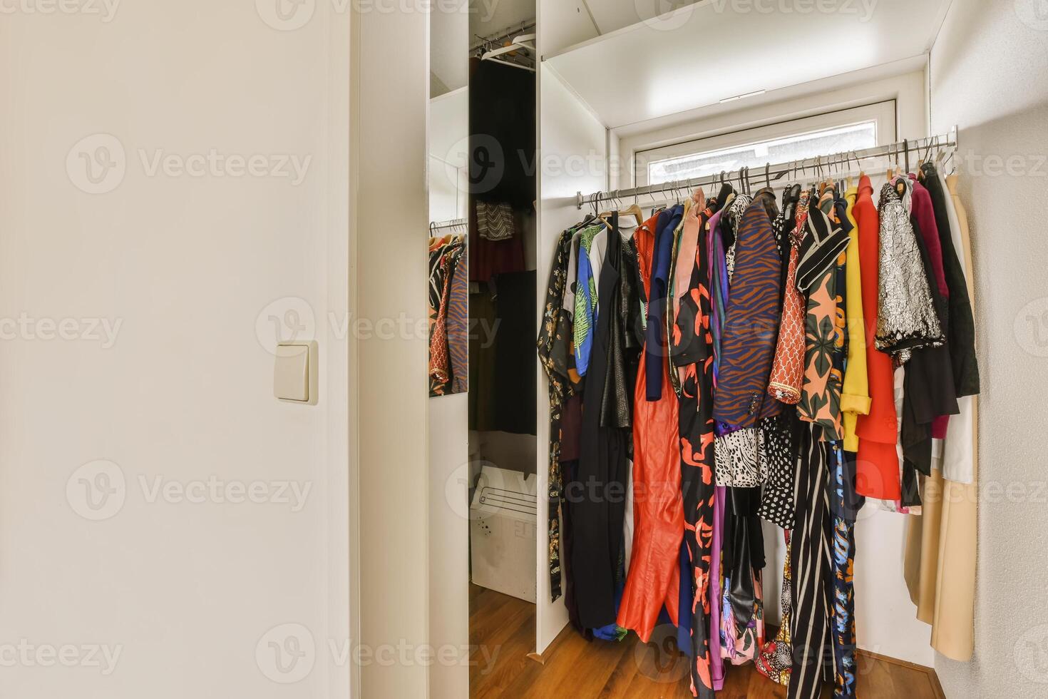A closet with clothes hanging on the wall photo