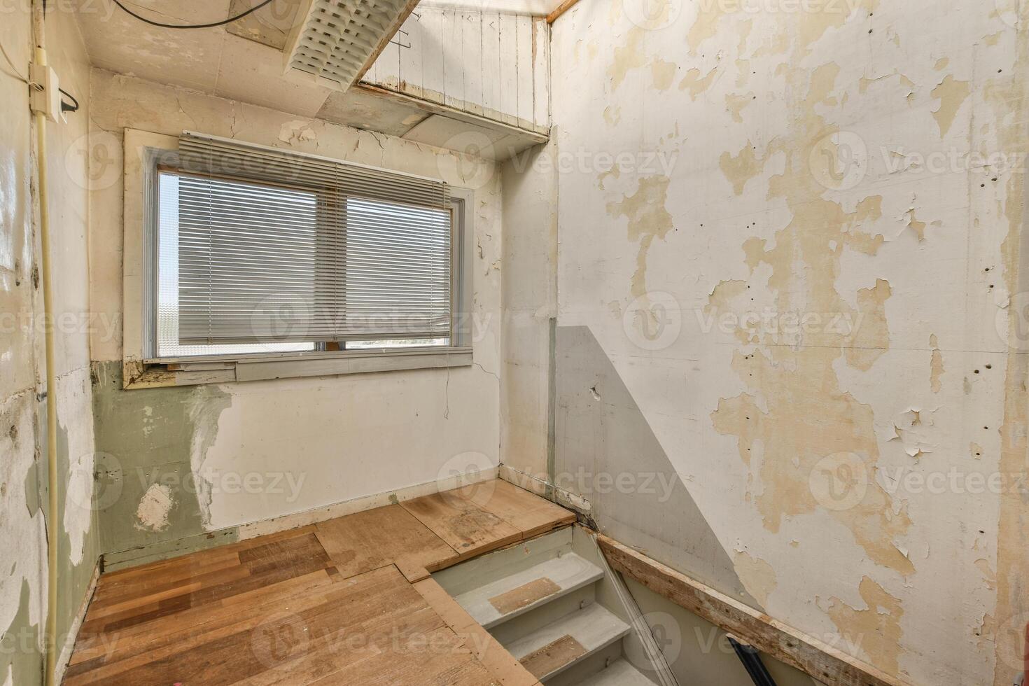 An empty room with a wooden floor and a window photo