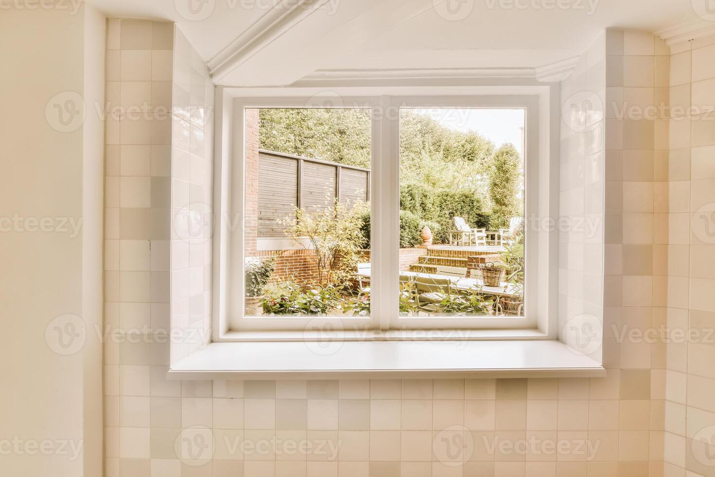 A bathroom with a window and a tub photo