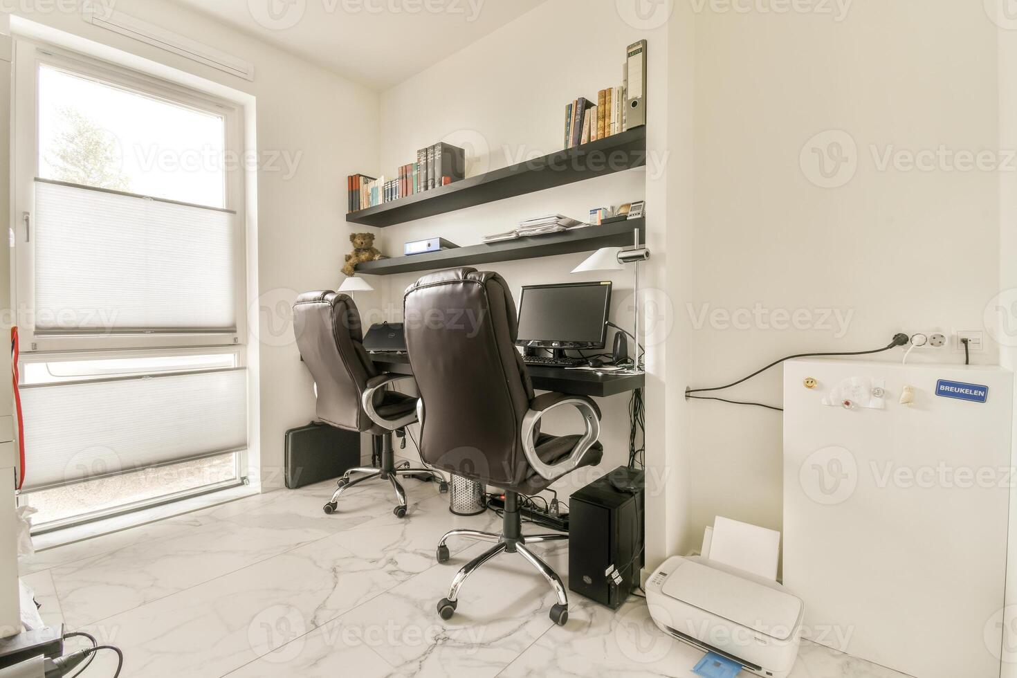 A white desk with two chairs photo