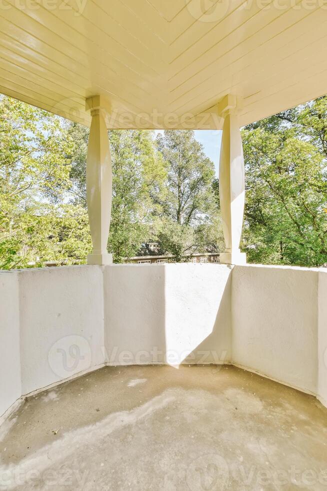 A porch with a white roof and columns photo