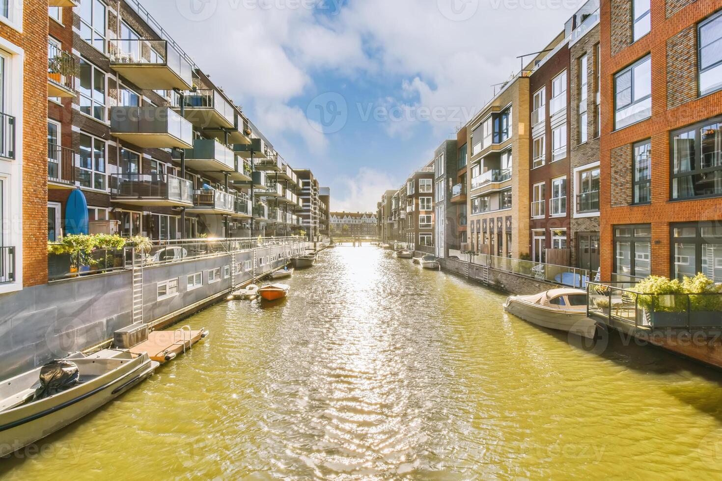 A canal with boats in it and buildings on either side photo