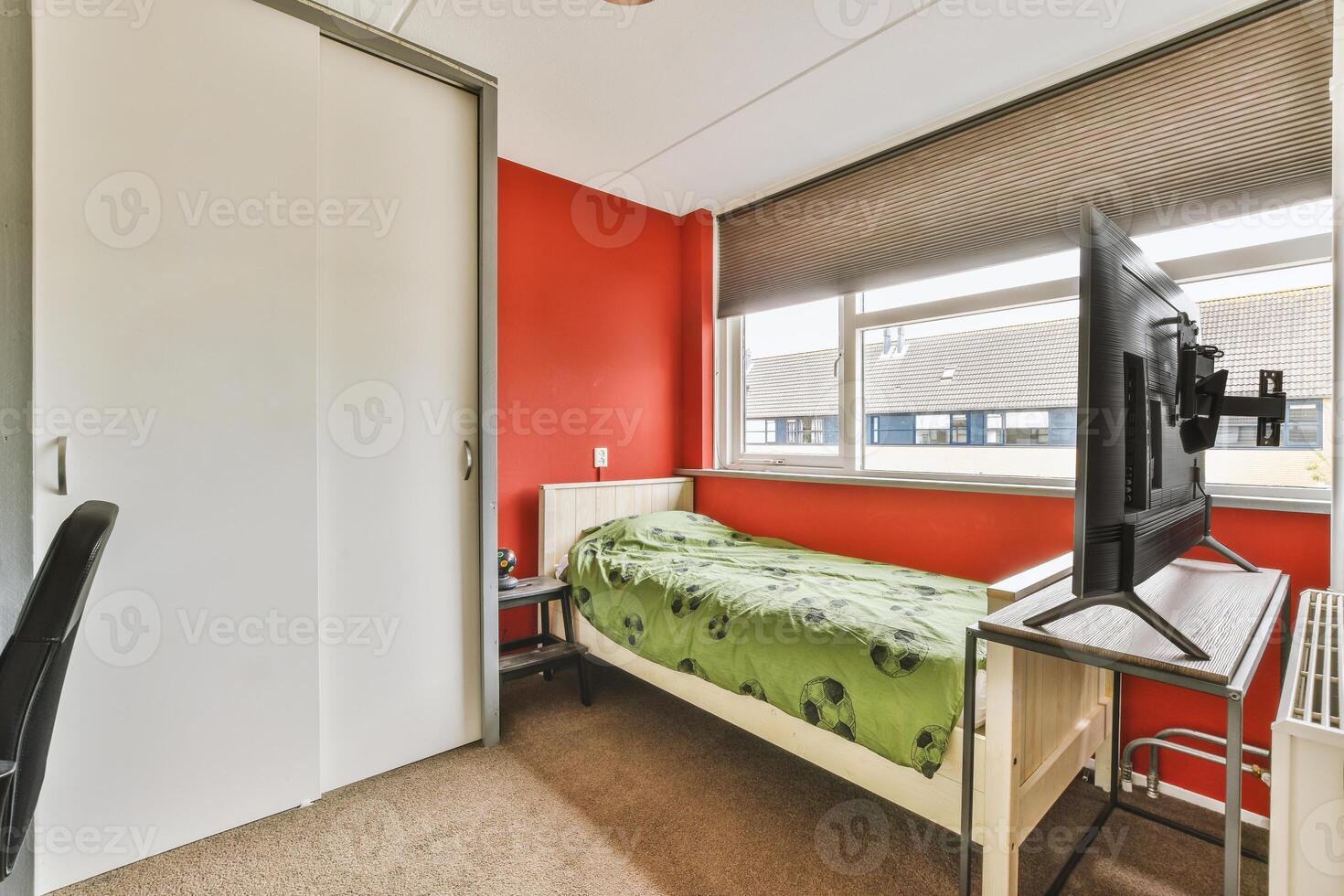 A bedroom with a bed and a tv in it photo