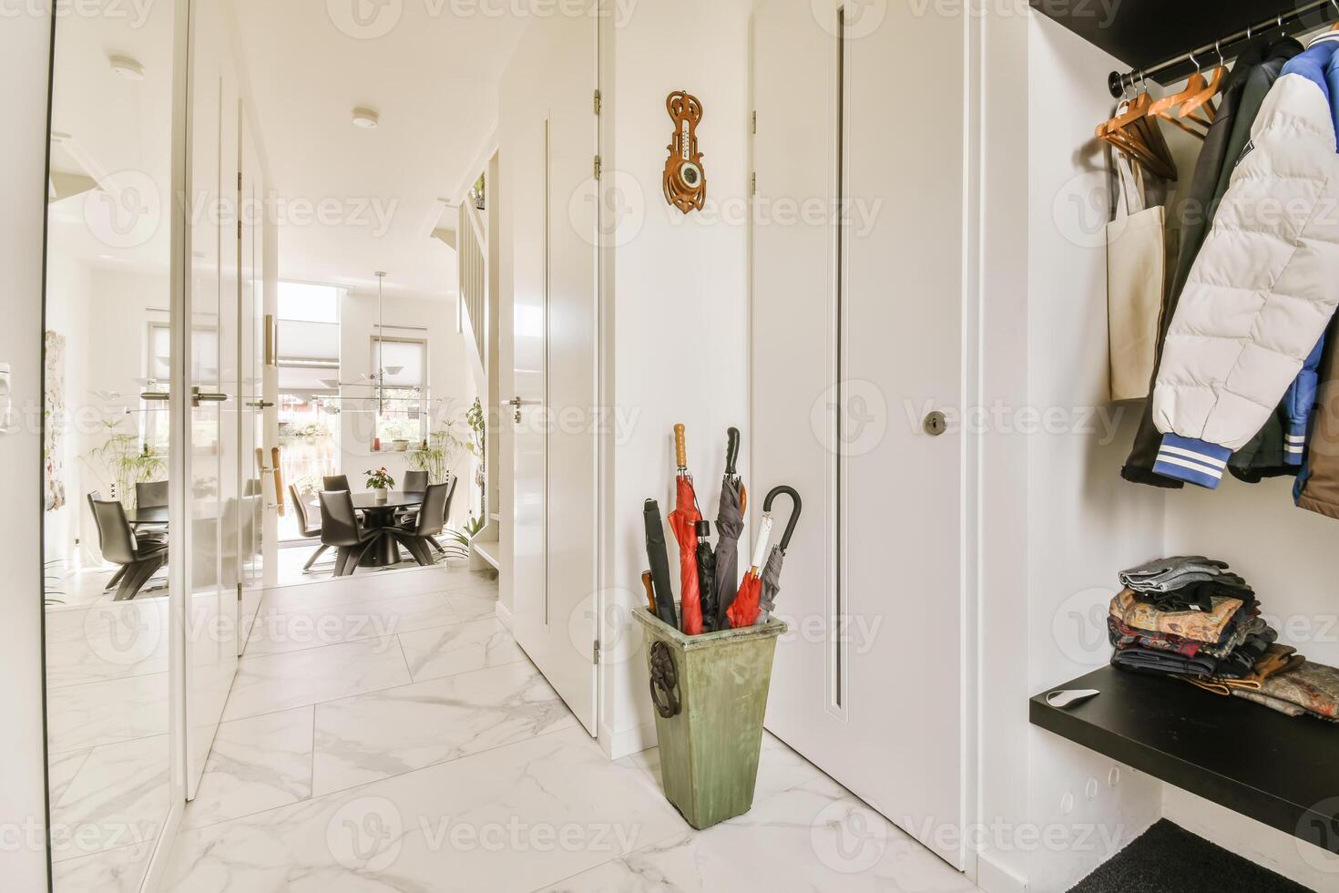 A hallway with a coat rack and umbrella photo