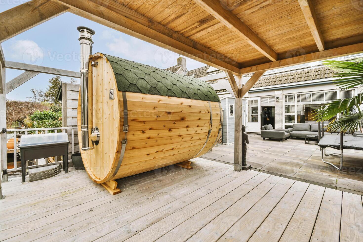 A wooden sauna on a deck with a patio photo
