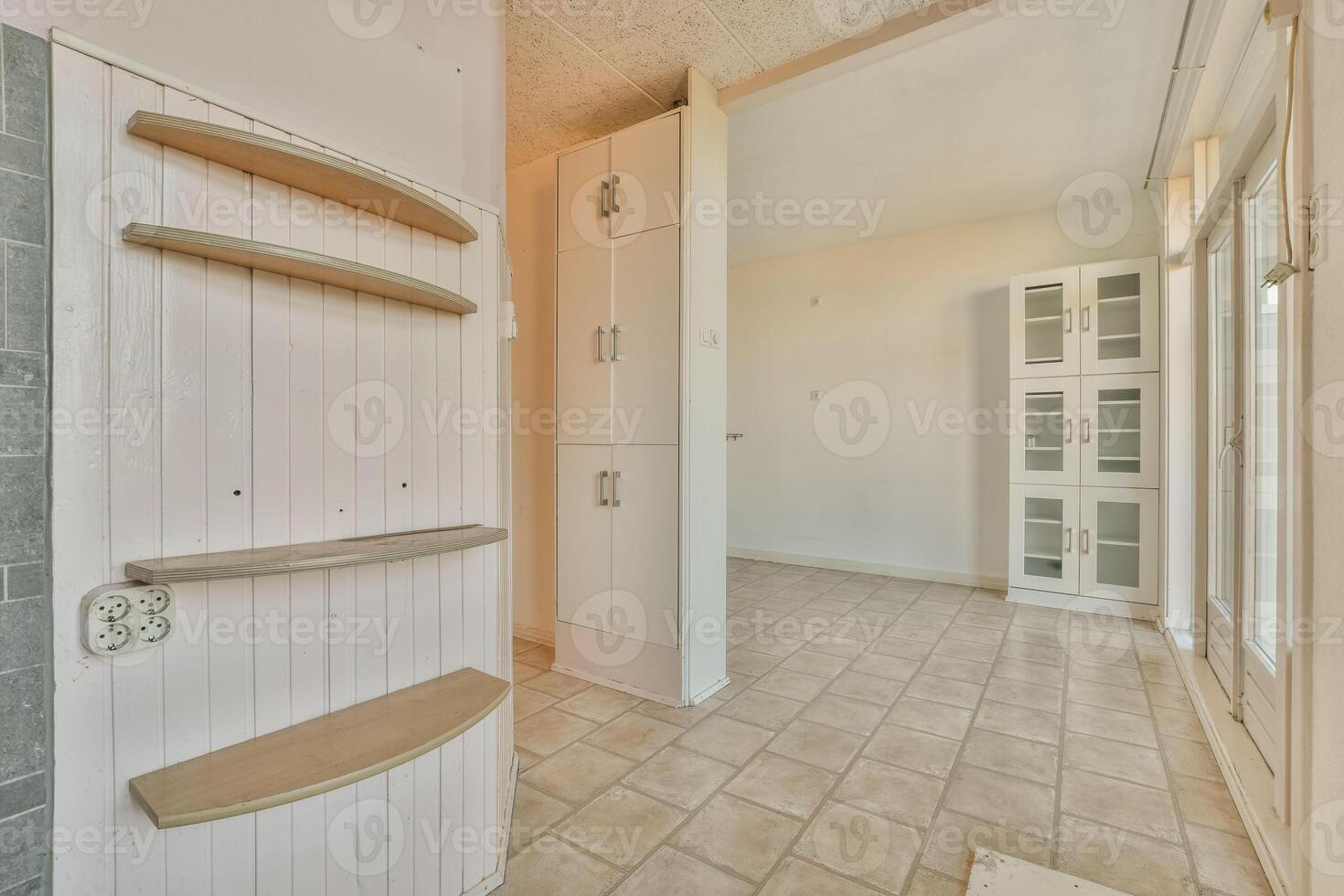 A room with a shelf and a door in it photo