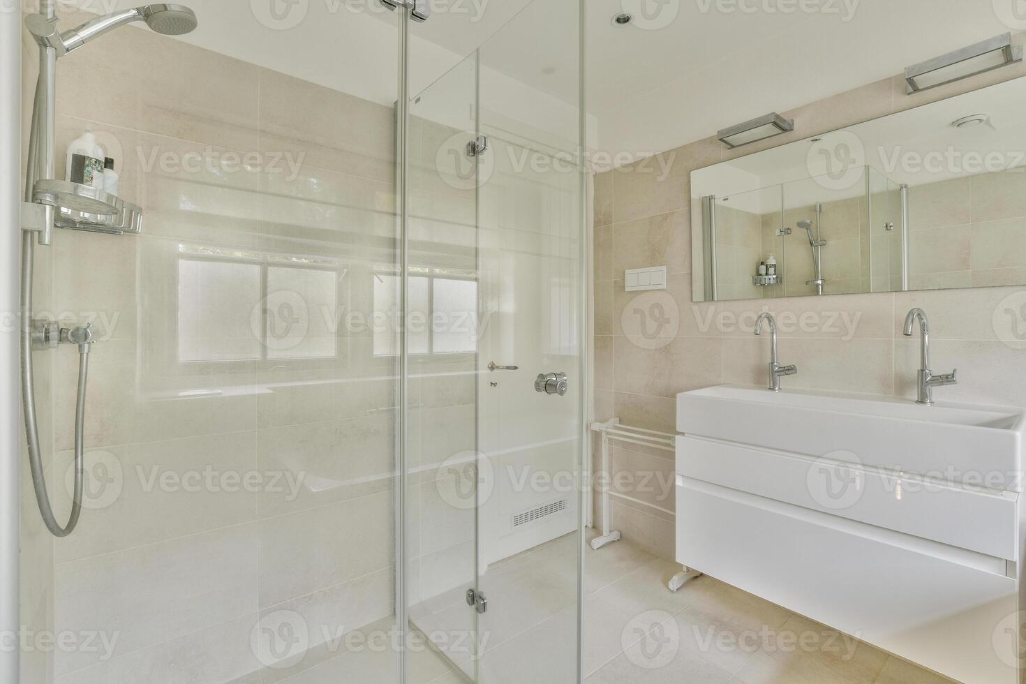 A bathroom with a glass shower stall and a sink photo