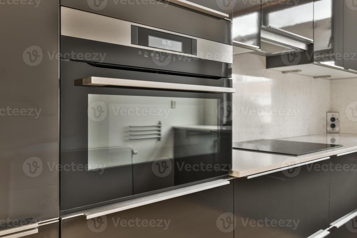Modern kitchen with stainless steel appliances and black cabinets photo