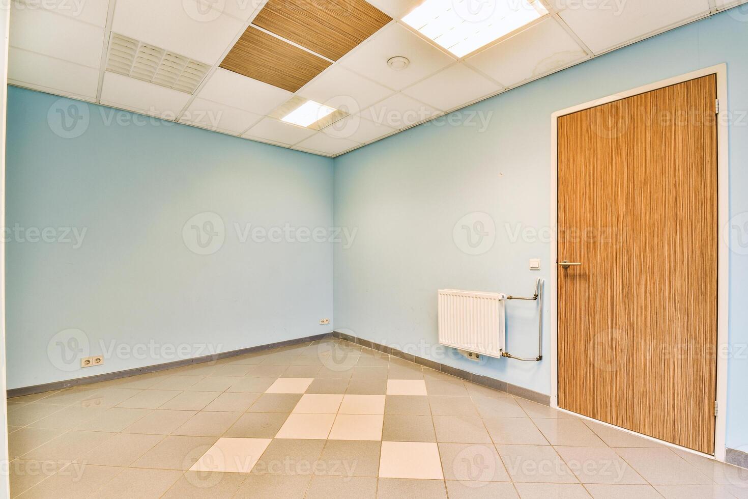 An empty room with a door and tile floor photo